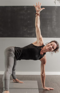 Woman in a yoga position with hand up
