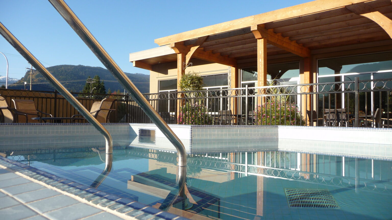 Outdoor hot tubs with a mountain backdrop at Revelstoke Wellness