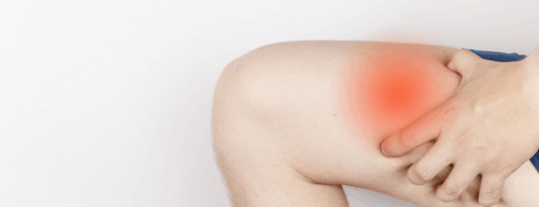 A close up of a knee and quadricep muscle, highlighted in red where the subject is suffering a muscle strain.
