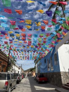 Street view with colorful flags overhead