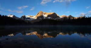 snow-capped mountains reflected on Mistaya Lake
