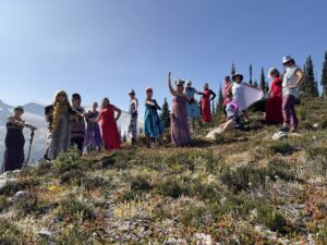 A group of woman all in costumes posing for the camera