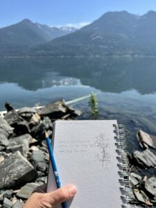 Picture of a sketch with a lake and mountains behind