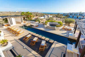 Looking down on the pool with the view of the ocean in the background